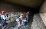 Inspecting a stormwater tunnel during river drawdown